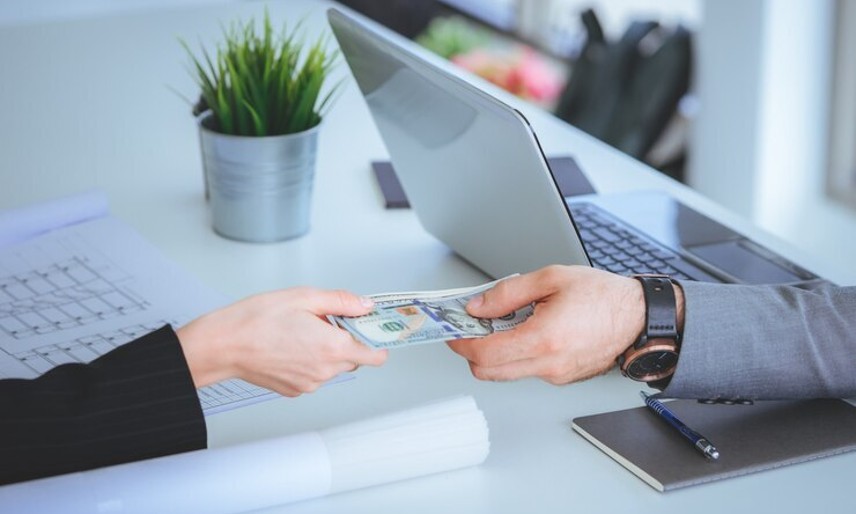 Person exchanging currency at a foreign exchange desk - CrossworldForex